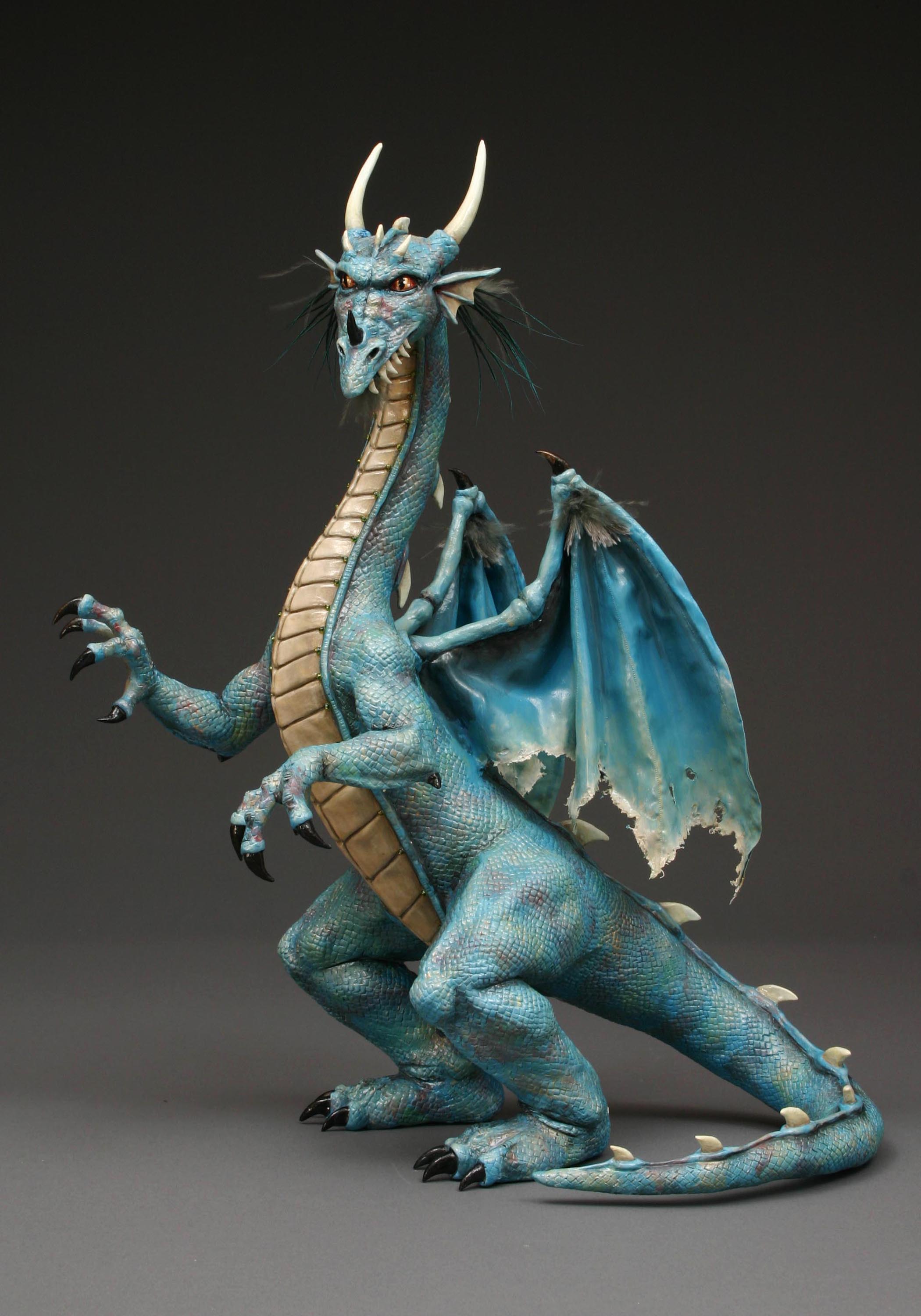 Painted sculpture of blue dragon using Creative Paperclay® and feathers standing up